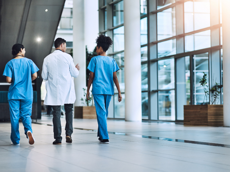 Doctors walking in a hall with glass walls